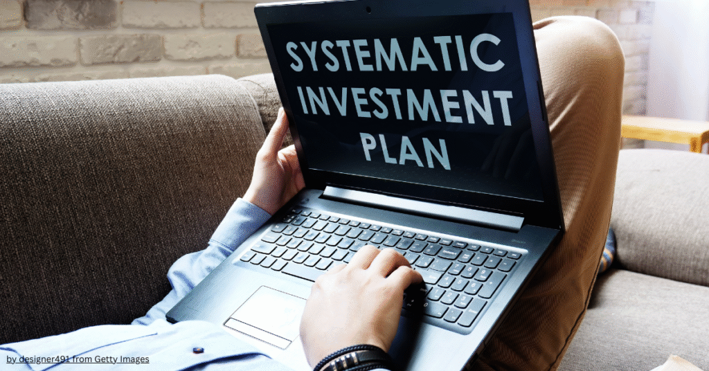 Difference between SIP and mutual fund – person researching Systematic Investment Plan (SIP) on laptop.